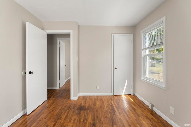 unfurnished bedroom featuring dark wood-type flooring