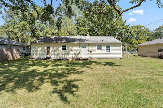 back of property featuring a lawn