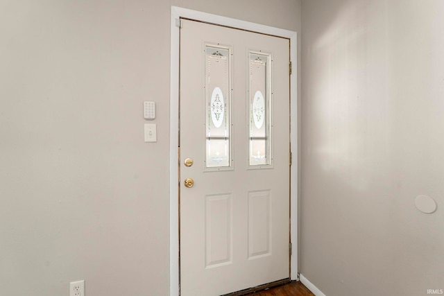 entryway with dark hardwood / wood-style flooring