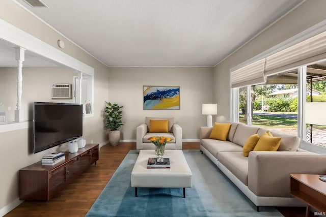 living room with dark hardwood / wood-style floors and a wall mounted air conditioner