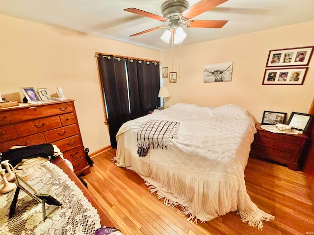 bedroom featuring wood-type flooring and ceiling fan