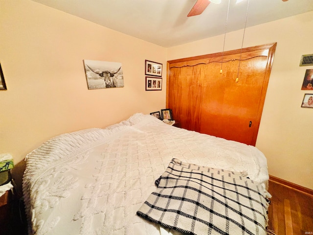 bedroom featuring a closet, hardwood / wood-style floors, and ceiling fan