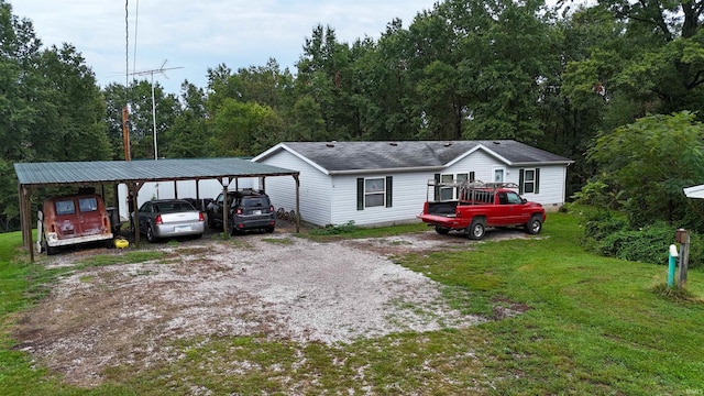 view of front of property with a front yard and a carport