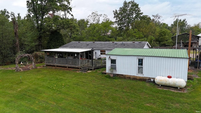 rear view of property with a deck and a yard