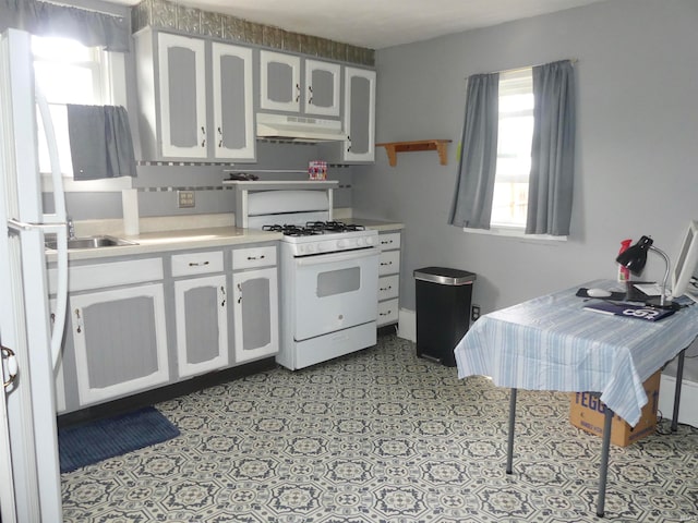 kitchen with white cabinets, sink, and gas range gas stove