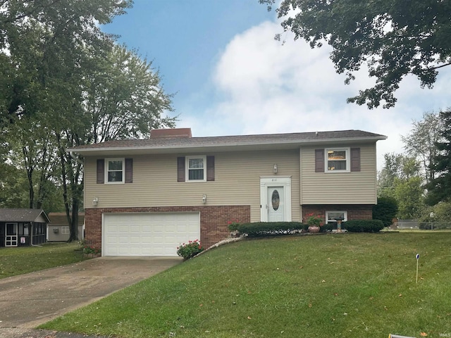 split foyer home featuring a front yard and a garage