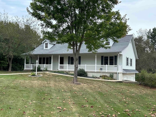 view of front of house with a front yard, a garage, and covered porch