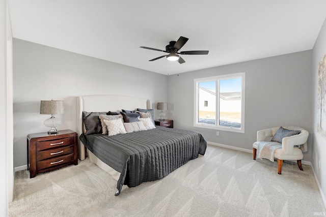 bedroom with ceiling fan and light colored carpet