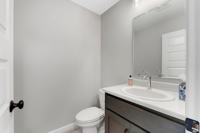 bathroom featuring toilet and vanity