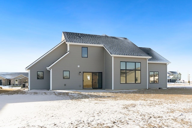 view of snow covered back of property