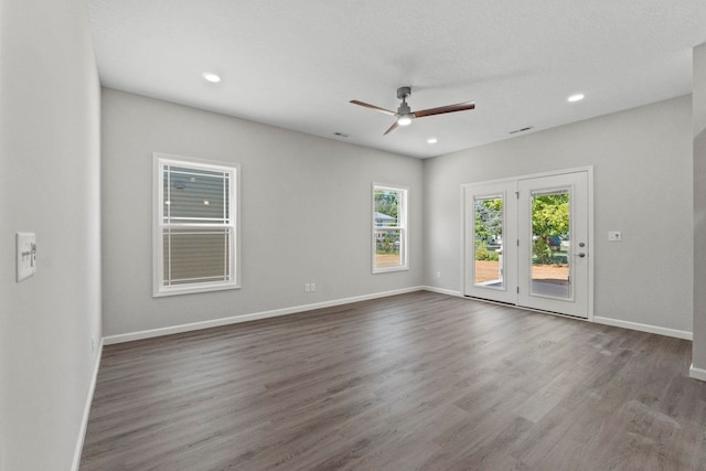 unfurnished room with ceiling fan, a textured ceiling, and dark hardwood / wood-style floors