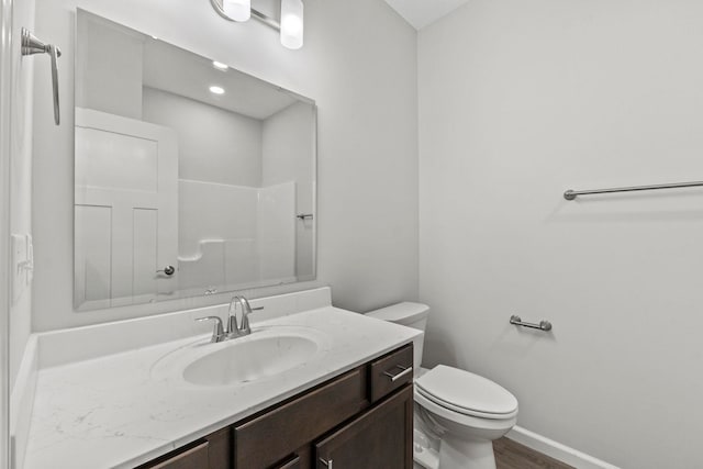 bathroom featuring vanity, toilet, and hardwood / wood-style flooring