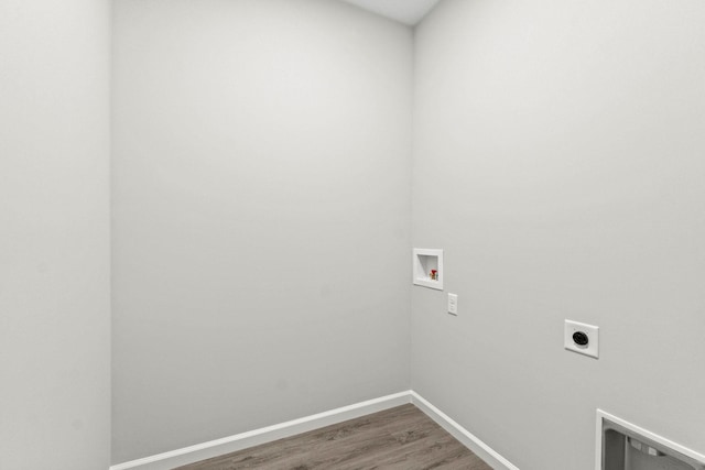 washroom featuring hookup for a washing machine, dark wood-type flooring, and electric dryer hookup