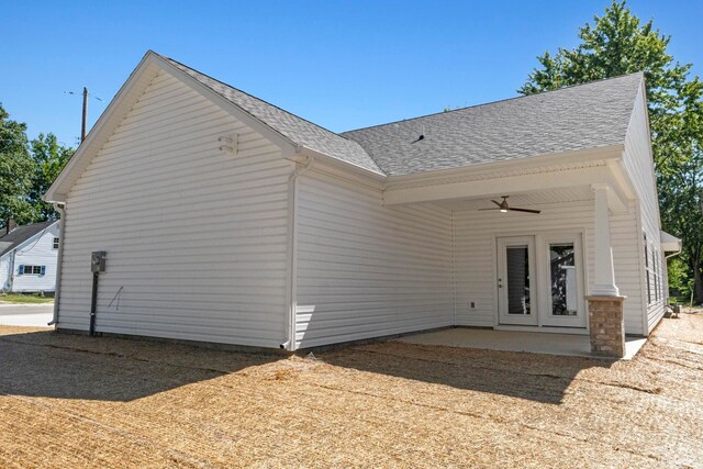 rear view of property with ceiling fan and a patio area