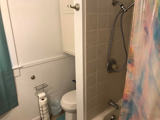 bathroom with shower / bath combination with curtain and toilet