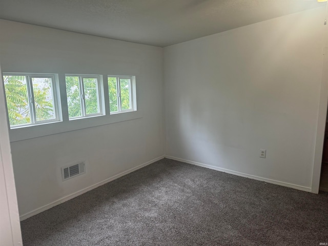 carpeted empty room featuring plenty of natural light