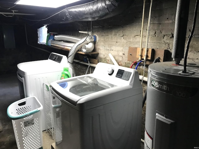 laundry area featuring electric water heater, electric panel, and separate washer and dryer