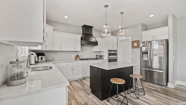 kitchen with custom exhaust hood, stainless steel appliances, white cabinetry, and a center island