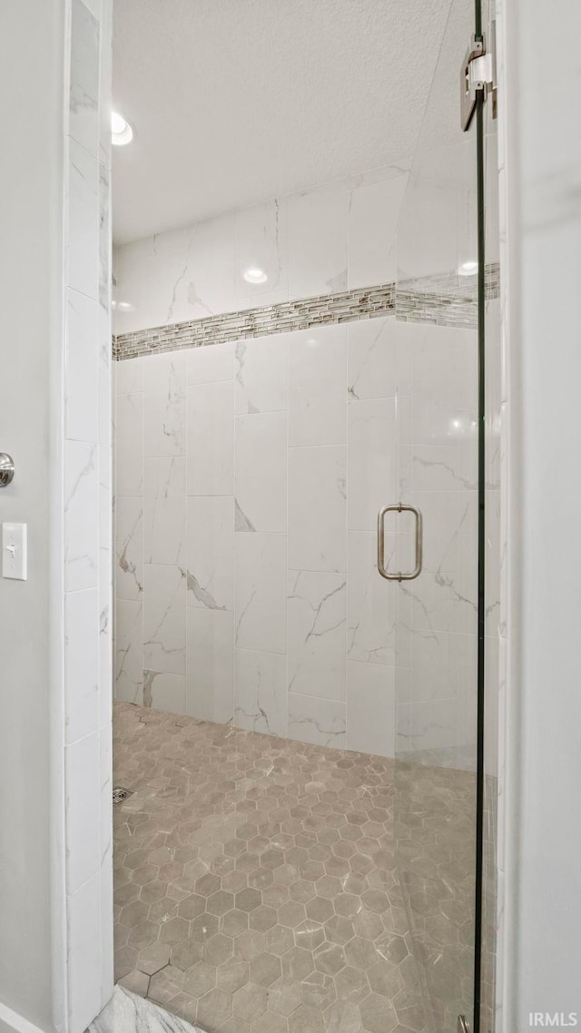 bathroom with a shower with shower door