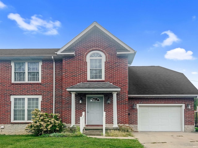 view of front facade featuring a front lawn and a garage