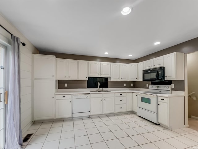 kitchen featuring white cabinetry, white appliances, sink, and light tile patterned floors