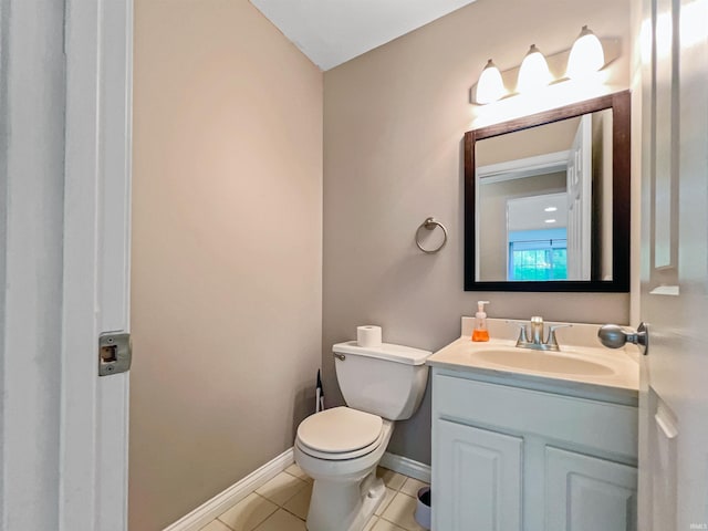 bathroom featuring tile patterned floors, vanity, and toilet