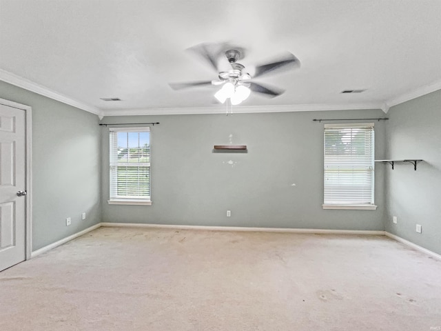 carpeted spare room featuring ceiling fan and crown molding