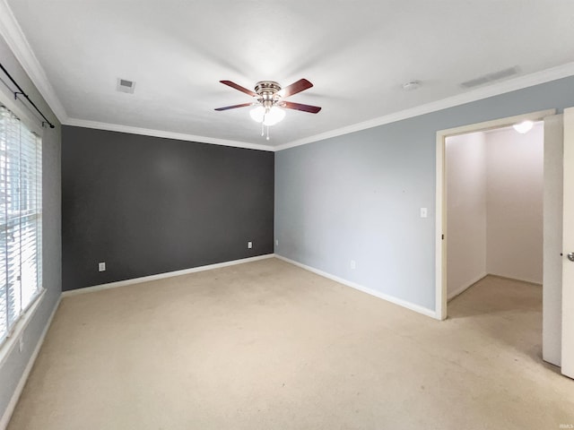 unfurnished room featuring crown molding, ceiling fan, and light carpet