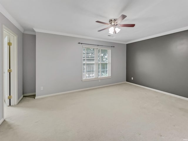 spare room with crown molding, ceiling fan, and light colored carpet