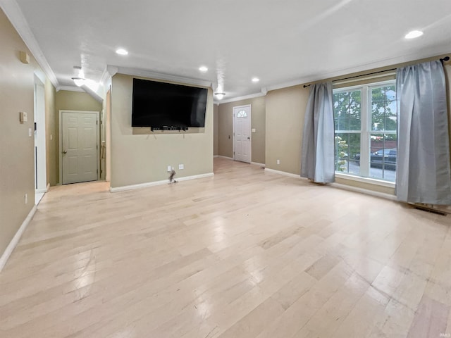 unfurnished living room featuring light hardwood / wood-style floors and crown molding