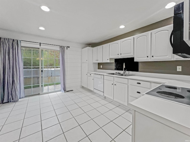 kitchen featuring dishwasher, white cabinetry, sink, and light tile patterned floors