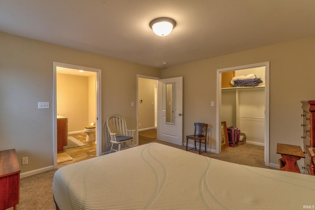 carpeted bedroom with a spacious closet, a closet, and ensuite bathroom