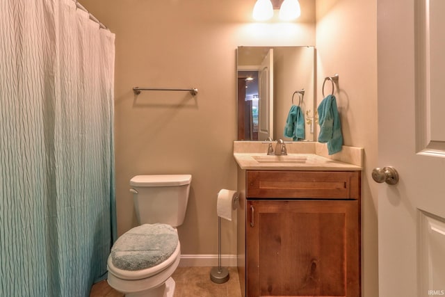 bathroom featuring tile patterned flooring, vanity, and toilet