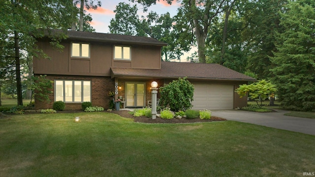 view of front of house with a yard and a garage