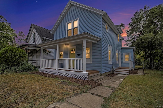 view of front of house with a lawn and covered porch