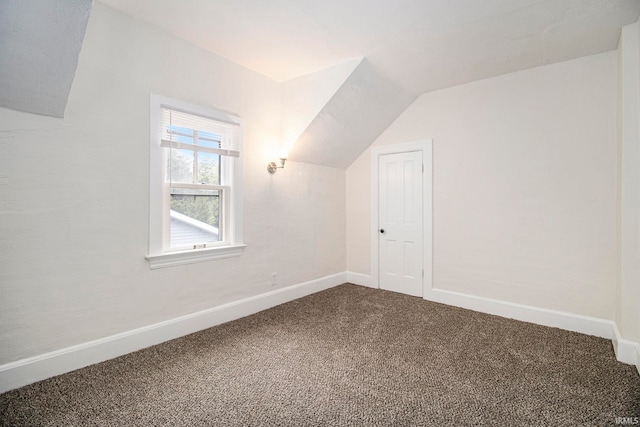 bonus room featuring lofted ceiling and carpet