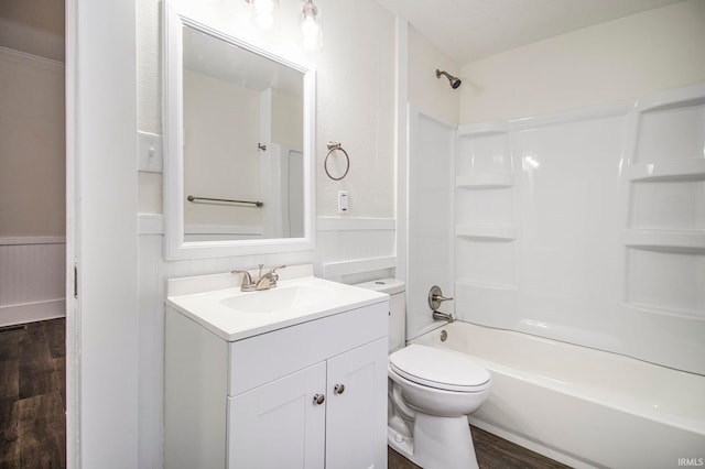 full bathroom with tub / shower combination, hardwood / wood-style floors, vanity, and toilet