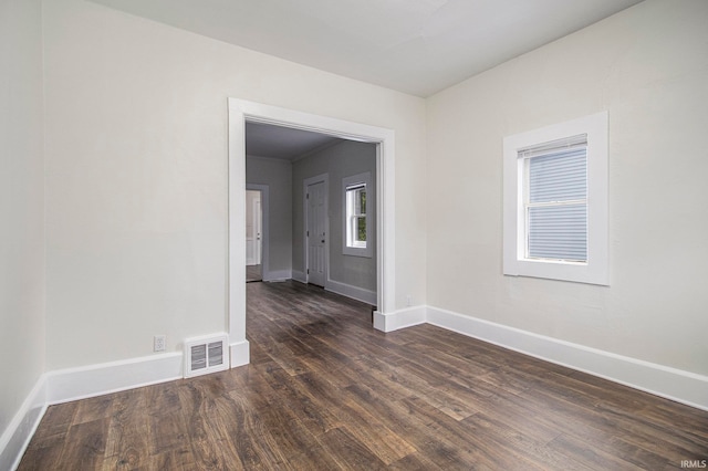 unfurnished room featuring dark hardwood / wood-style flooring