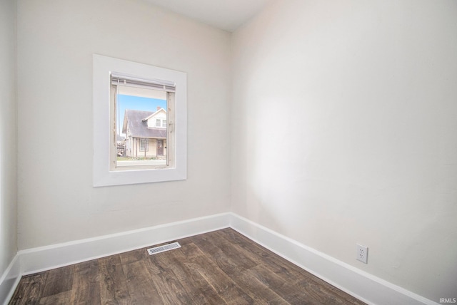 spare room with dark hardwood / wood-style floors