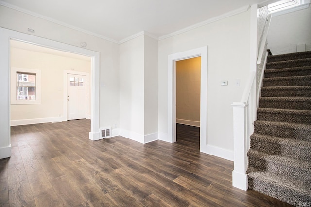 unfurnished living room featuring crown molding and dark hardwood / wood-style floors