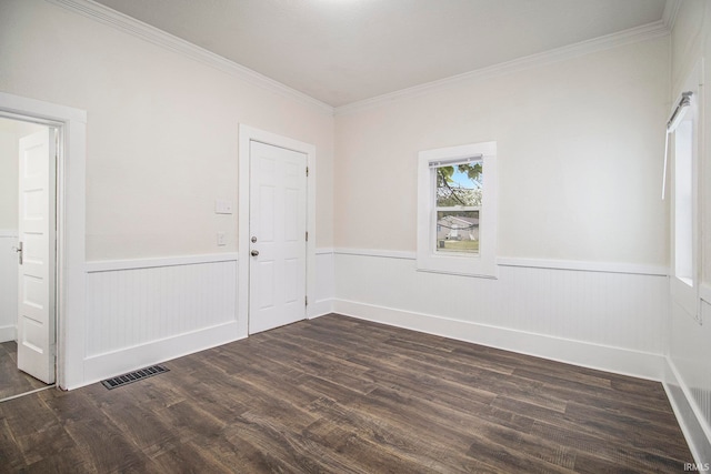 spare room featuring crown molding and dark hardwood / wood-style flooring