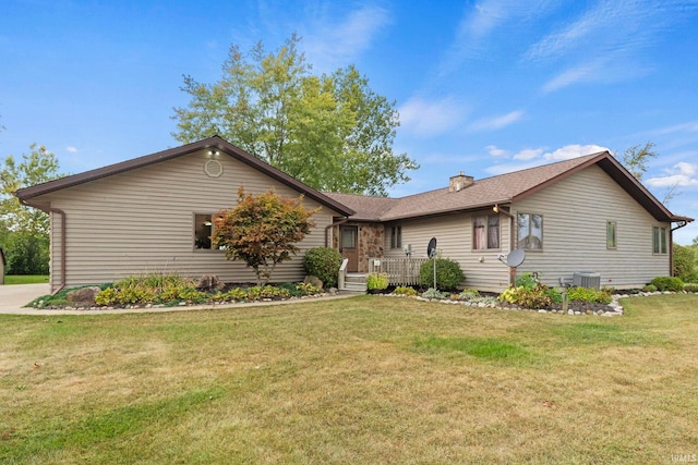 single story home with central AC and a front yard