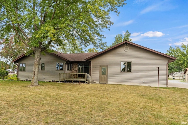 back of house featuring a deck and a yard