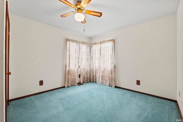 carpeted spare room with ceiling fan