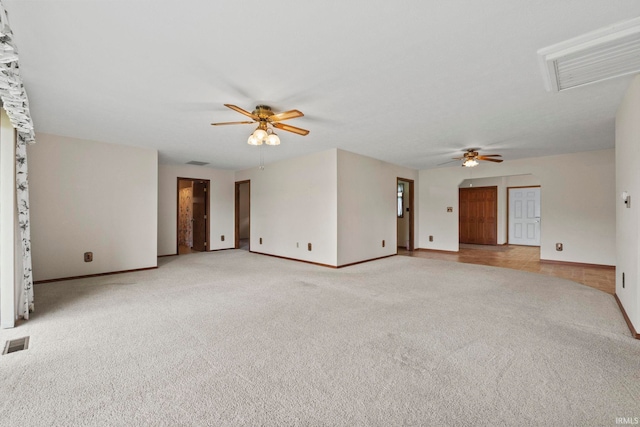 carpeted spare room with ceiling fan