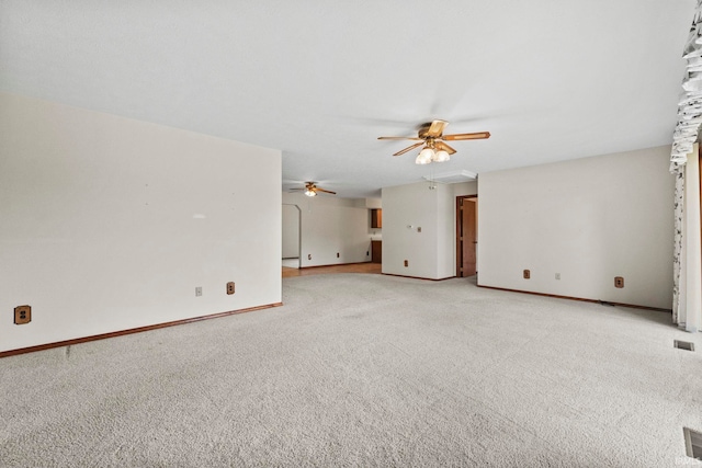 empty room with ceiling fan and light colored carpet