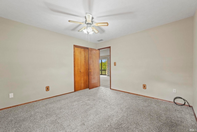 carpeted empty room with ceiling fan