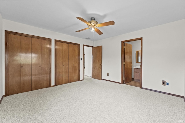 52 Ems B40A1 Ln, Leesburg, IN 46538 - unfurnished bedroom featuring two closets, baseboards, carpet flooring, and ensuite bath