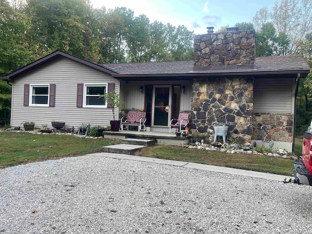 single story home featuring a front lawn and covered porch