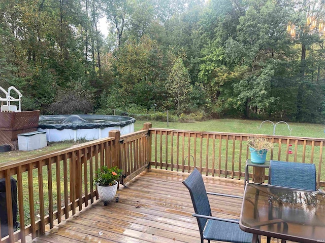 deck with a covered pool and a yard